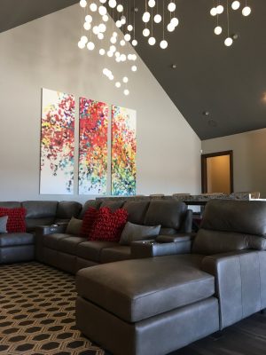 abstract art on wall in living room with sofa and modern lighting